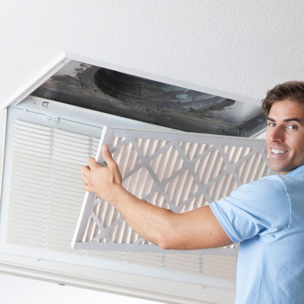 Professional technician cleaning residential air duct with specialized equipment
