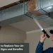 Technician inspecting a damaged air duct with a flashlight to determine if air duct replacement is needed.